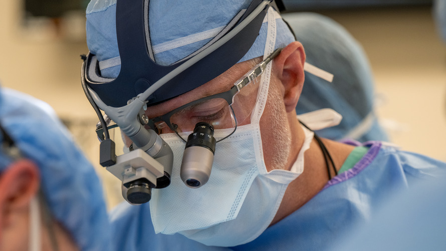 Dr. Johnston wearing scrubs in an operating room.