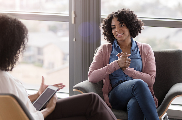 Woman sitting in a chair attending a counseling session.