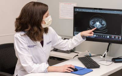 Northwestern Medicine oncologist doctor Sarah Fenton pointing to a scan on a computer screen.