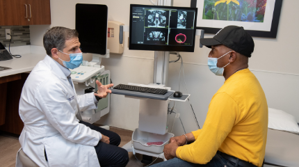 A Northwestern Medicine physician discussing scans with a cancer patient.