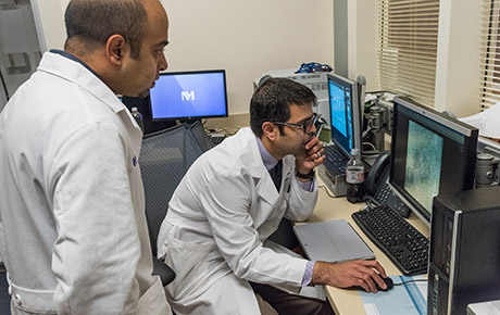 Two physicians reviewing the scan of a patient in the pancreaticobiliary program at Northwestern Memorial Hospital.