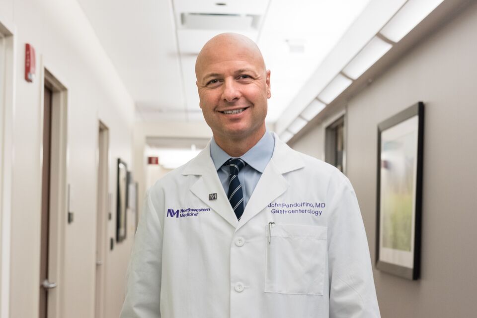 Northwestern Medicine gastroenterologist standing in a clinic hallway wearing a white lab coat.
