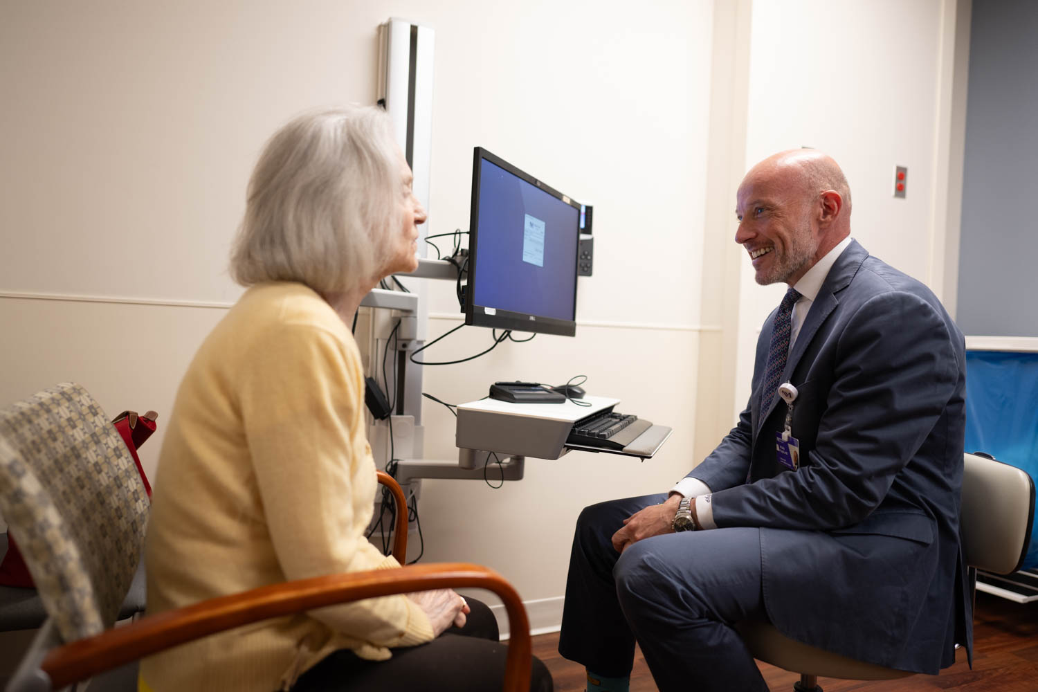 Northwestern Medicine physician speaking with a patient during a consultation in an exam room.