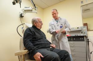 Physician who specializes in ENT explains something to a patient
