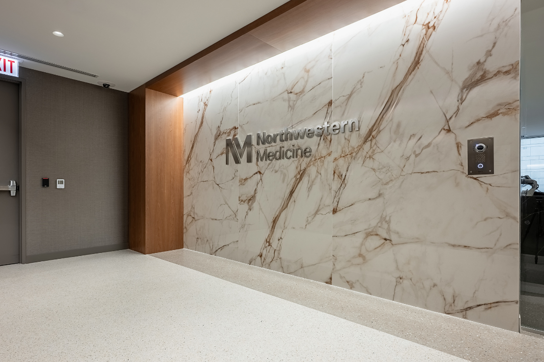 A marble wall with the Northwestern Medicine logo.