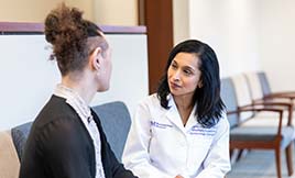 Dr. Angela Chaudhari talking with a gender pathways patient.