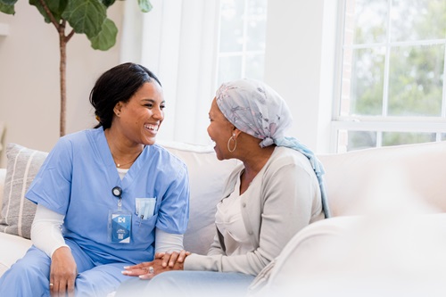 patient and care provider converse warmly at home