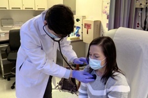 NM physician checks patient