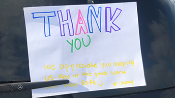 Thank you note attached to car in parking lot