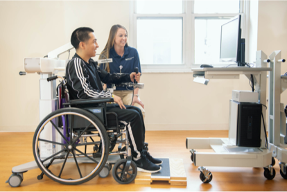 Patient in a wheelchair being assisted by a Marianjoy rehabilitation specialist.