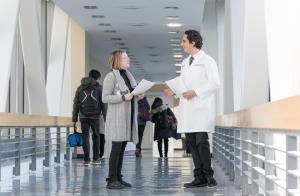 Physician talking with a colleague on a Northwestern Medicine bridge