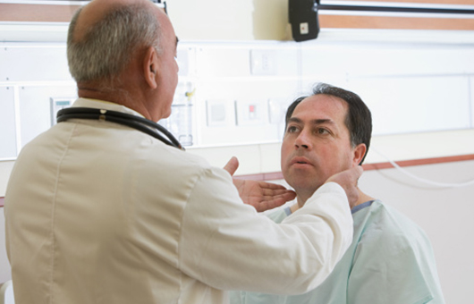 Doctor feeling patient nodes under neck, cranial base tumors