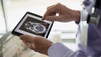 A physician examining a patient's brain scan.