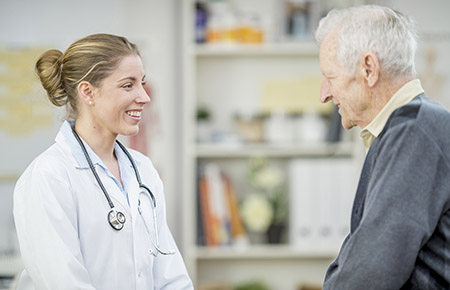 A female physician talking with an elderly male neurobehavior and memory clinic patient.