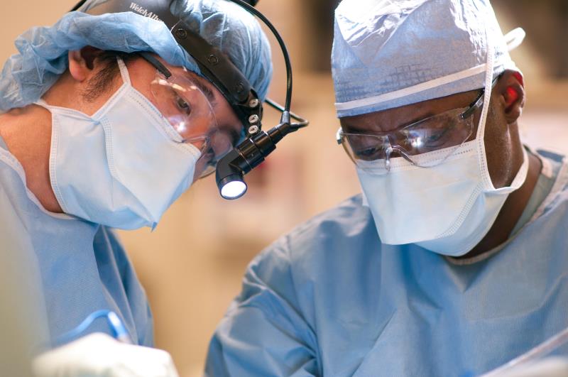 Expert Care for Pituitary Tumors. Two physicians performing surgery.