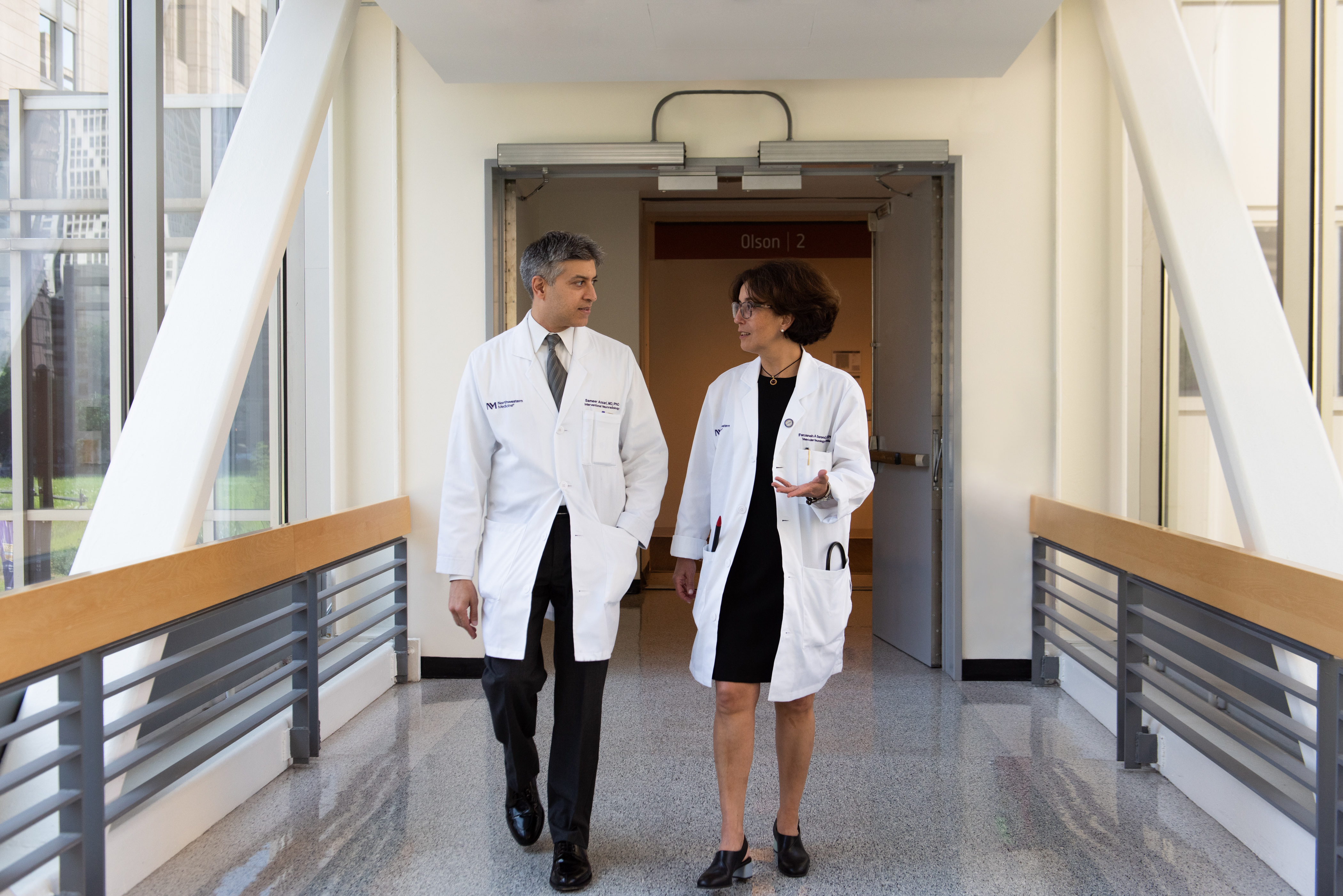 Neurology team discuss outside Olson Pavilion