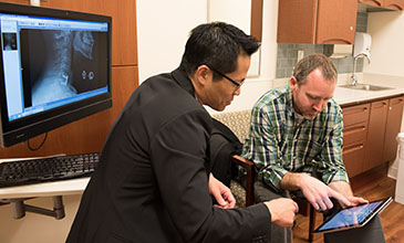 Northwestern Medicine physician Dr. Wellington Hsu examining a patient.