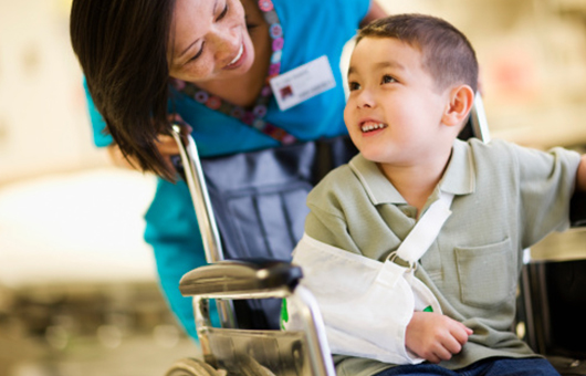 Northwestern Medicine boy leaving hospital with a broken arm in a wheelchair