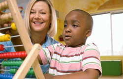 Northwestern Medicine child with teacher playing with toy pediatric behavioral health