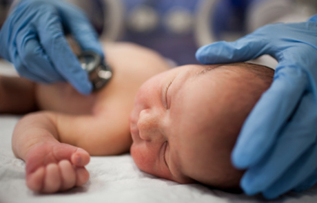 Northwestern Medicine doctor examining newborn in delnor nursery