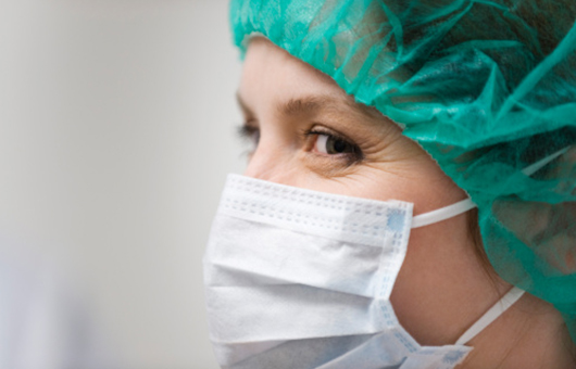 Nurse pre-operation smiling under mask pediatric surgery