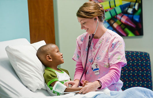 Nurse talks to young patient