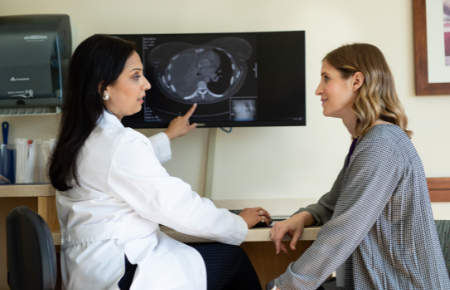 A physician discussing a MRI scan with a patient.