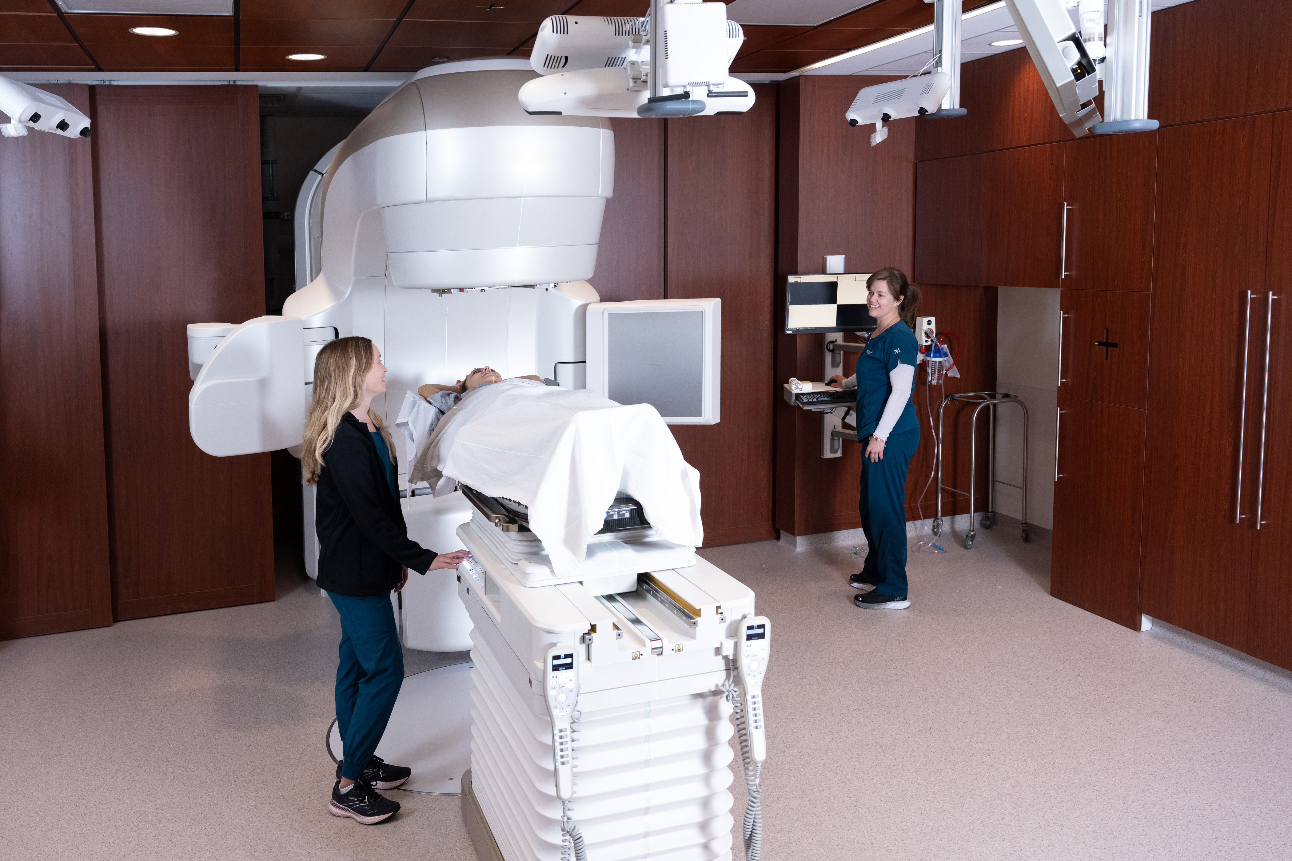 Radiation oncology care team with patient receiving treatment