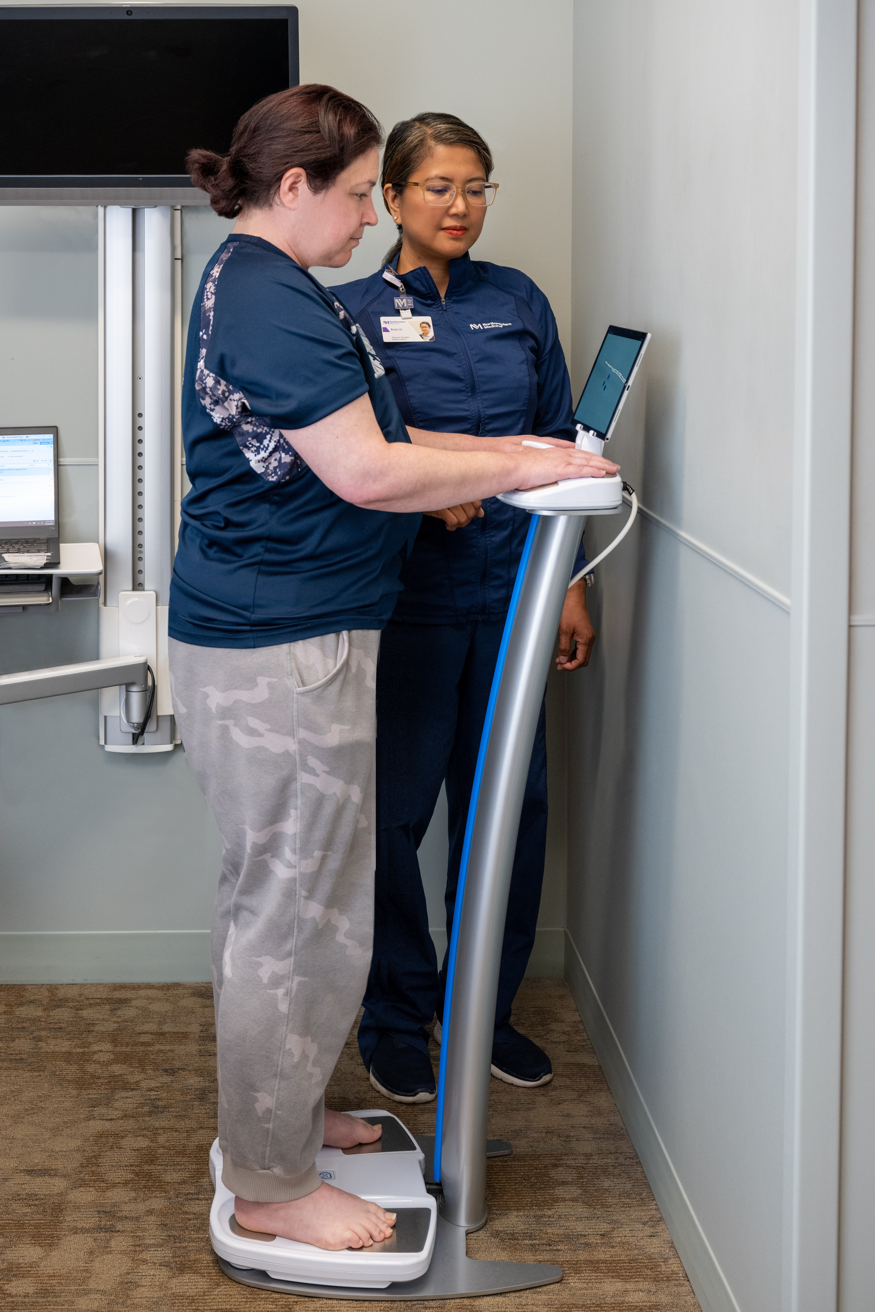 patient stepping on a sozo machine with medical professional next to them