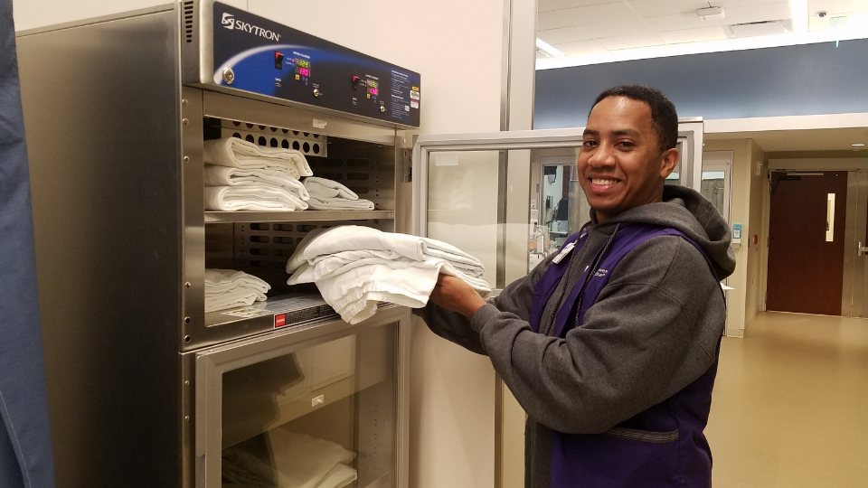 A Northwestern Medicine volunteer warming towels during their shift.