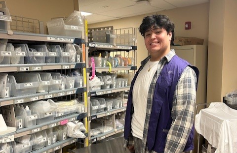 Kish Volunteer wearing a purple NM vest and checkered shirt.