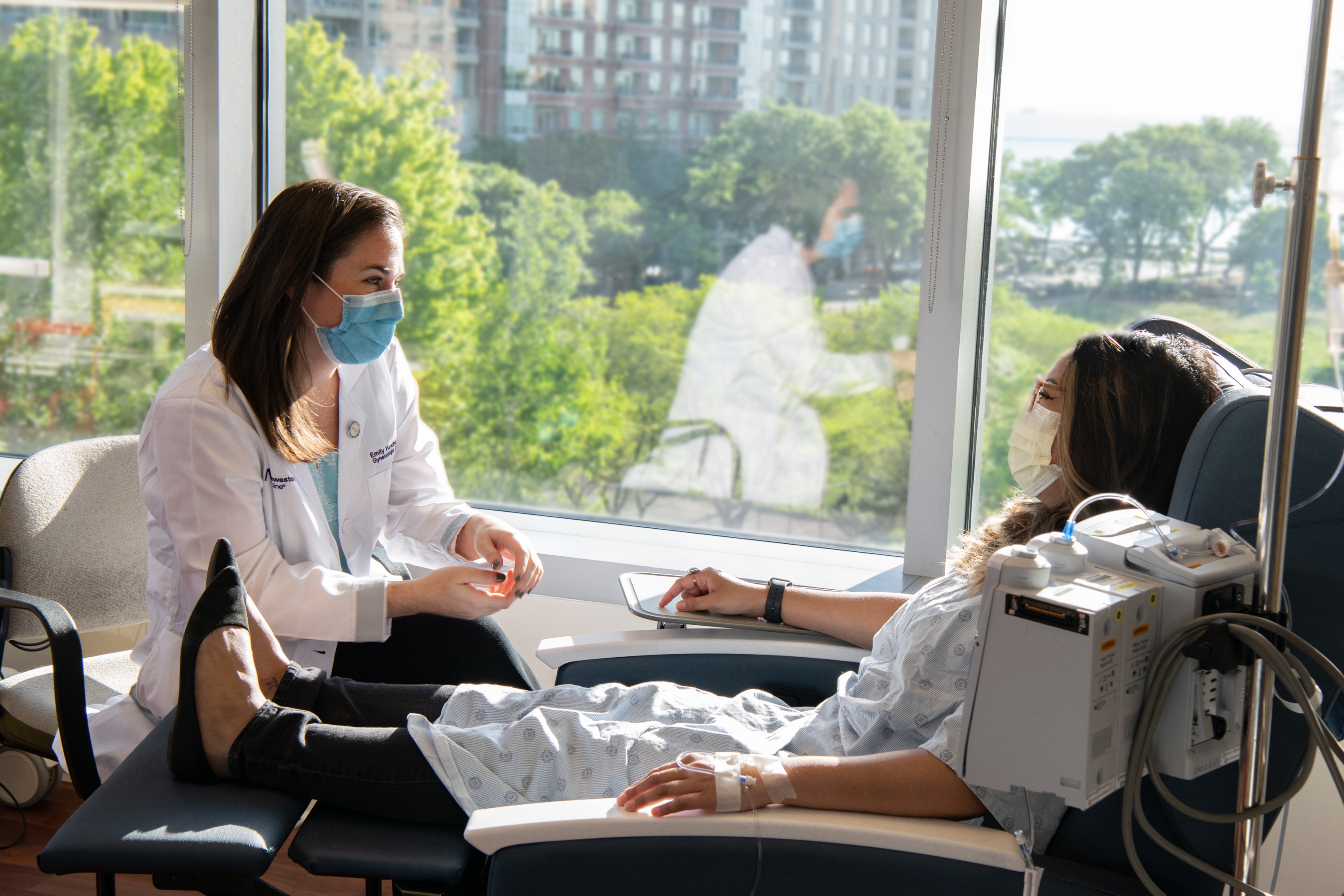 physician and patient conversing while seated