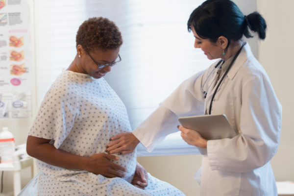 Doctor with a patient in an exam room 