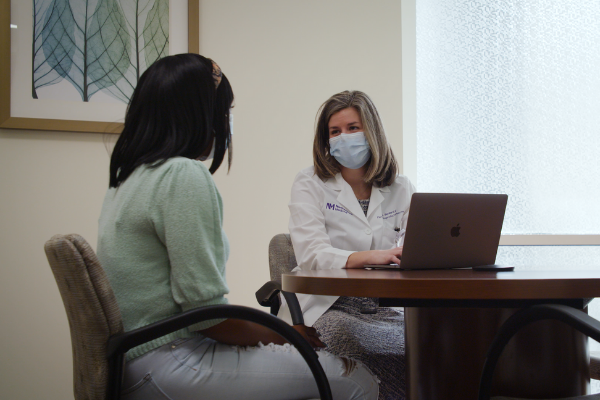 Dr. Bernardi meets with an African American patient, discussing recurrent pregnancy loss solutions