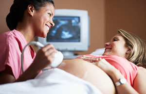 Woman receiving ultrasound from nurse