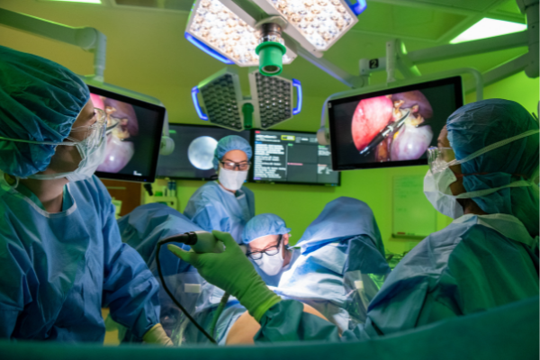 Surgeons performing minimally invasive surgery on a pregnant woman