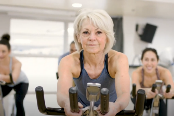 Older woman participating in a spin class