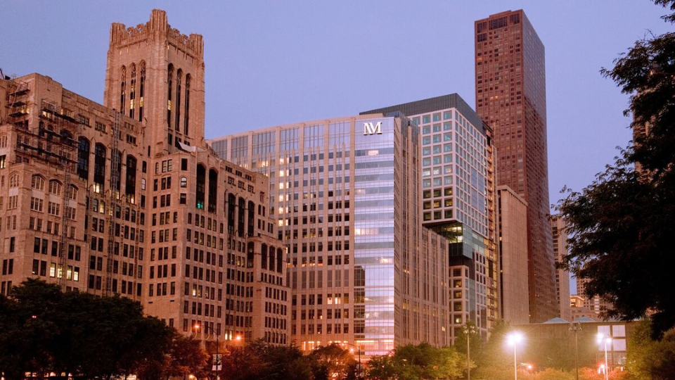 Northwestern Memorial Hospital and surrounding Chicago buildings at dusk.