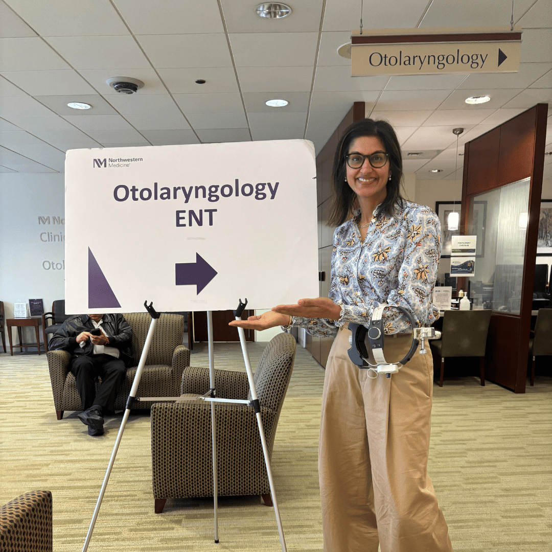 Sleep surgeon Reena Dhanda-Patil, MD, standing next to a sign that says "Otolaryngology ENT"