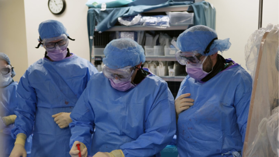 Three surgeons in an operating room.