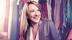 Amy Ross smiling in front of wardrobe