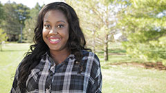 Rebekah smiling in a park