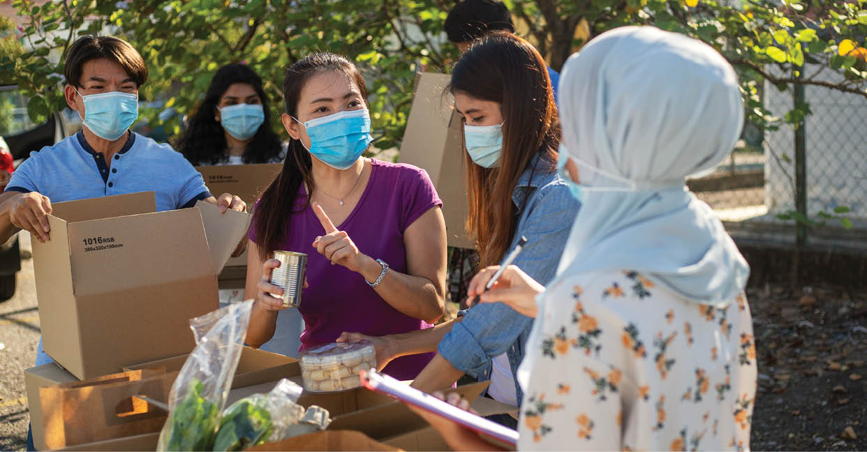 Group of charity workers working together, help collecing food for homeless victims