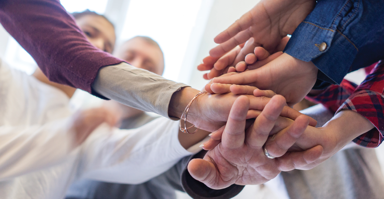 Hands together in circle with copy space above