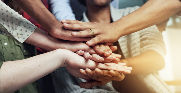 Shot of a group of people putting their hands together