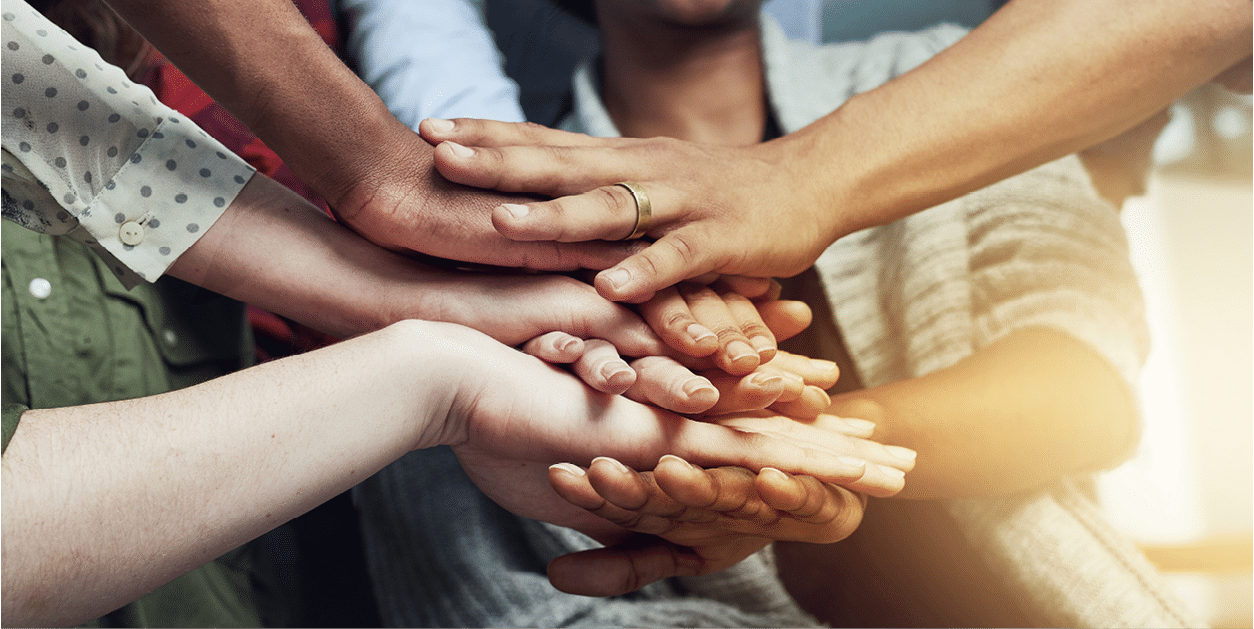 Shot of a group of people putting their hands together