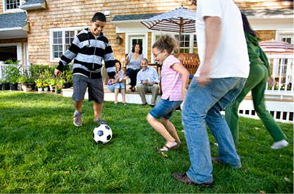 A boy and a girl playing with a soccer ball. Description generated by AI