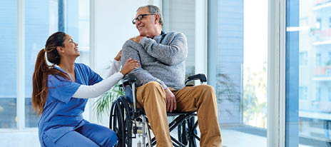 Shot of a young nurse caring for a senior man in a wheelchair