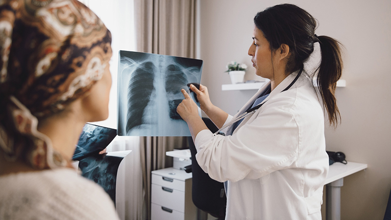 Physician showing patient an X-Ray image.