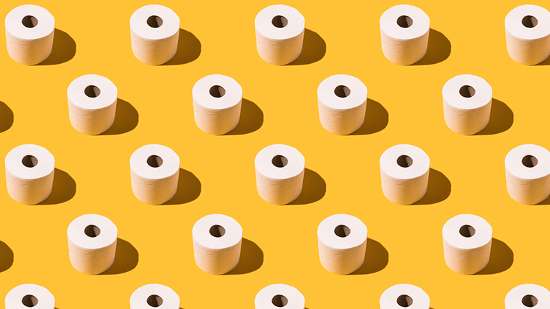 White rolls of toilet paper in a repeating pattern on a solid yellow background.